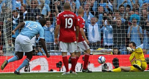 Manchester City's Ivorian footballer Yaya Toure (L)  scores a goal against Stoke during the FA Cup final football match between Manchester City and Stoke City at Wembley Stadium in London, on May 14, 2011. AFP PHOTO / ADRIAN DENNIS
NOT FOR MARKETING OR ADVERTISING USE/RESTRICTED TO EDITORIAL USE (Photo credit should read ADRIAN DENNIS/AFP/Getty Images)