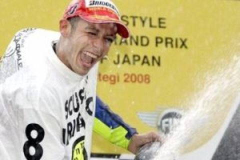 Yamaha MotoGP rider Valentino Rossi of Italy sprays champagne on the podium after winning this year's MotoGP championships after the Japan Motorcycle Grand Prix at Twin Ring Motegi circuit in Motegi, north of Tokyo, Sunday, Sept. 28, 2008.  Rossi took won the title with the victory in Sunday's race. (AP Photo/Shuji Kajiyama)