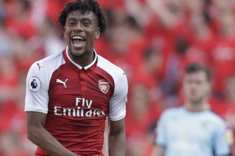 Arsenal's Alex Iwobi celebrates scoring his team's fourth goal during the English Premier League soccer match between Arsenal and Burnley at the Emirates Stadium in London, Sunday, May 6, 2018. The match is Arsenal manager Arsene Wenger's last home game in charge after announcing in April he will stand down as Arsenal coach at the end of the season after nearly 22 years at the helm. (AP Photo/Matt Dunham)