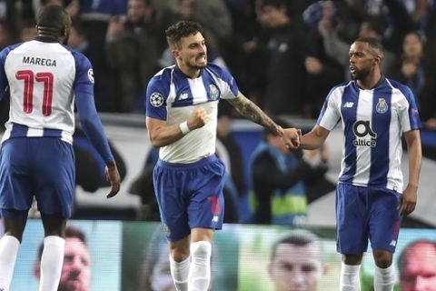 Porto defender Alex Telles, center, celebrates after scoring his side's third goal during the Champions League round of 16, 2nd leg, soccer match between FC Porto and AS Roma at the Dragao stadium in Porto, Portugal, Wednesday, March 6, 2019. (AP Photo/Luis Vieira)