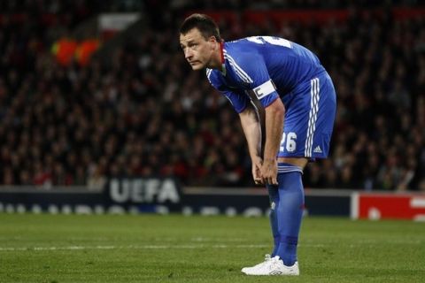 Chelsea's John Terry adjusts his socks during their Champions League quarter-final second leg soccer match against Manchester United at Old Trafford in Manchester, northern England, April 12, 2011.   REUTERS/Darren Staples  (BRITAIN - Tags: SPORT SOCCER)