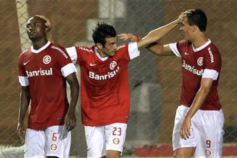 Datolo of Brazil's Internacional, center, celebrates with teammates Kleber, left, and Leandro Damiao after scoring against Peru's Juan Aurich during a Copa Libertadores soccer match in Porto Alegre, Brazil, Thursday Feb. 9, 2012. (AP Photo/Nabor Goulart)