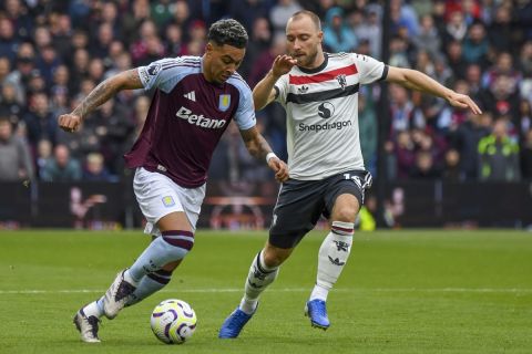 Aston Villa's Morgan Rogers, left, duels for the ball with Manchester United's Christian Eriksen during the English Premier League soccer match between Aston Villa and Manchester United, at Villa Park in Birmingham, England, Sunday, Oct. 6, 2024. (AP Photo/Rui Vieira)