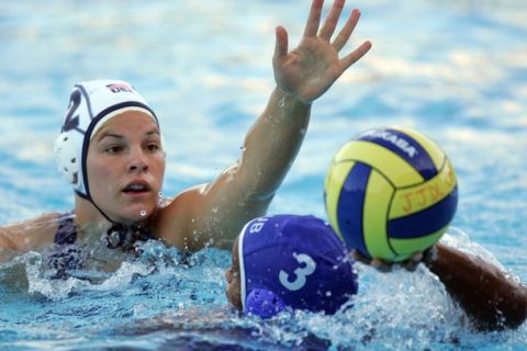 Rio de Janeiro, BRAZIL: US player Kami Craig (white cap) tries to block Cuban player Yadira Oms (Blue cap) during the women's waterpolo semifinal match at the Julio de Lamare Aquatic Center for Rio 2007 Pan American Games in Rio de Janeiro, Brazil, 19 July 2007. AFP PHOTO/Evaristo SA (Photo credit should read EVARISTO SA/AFP/Getty Images)