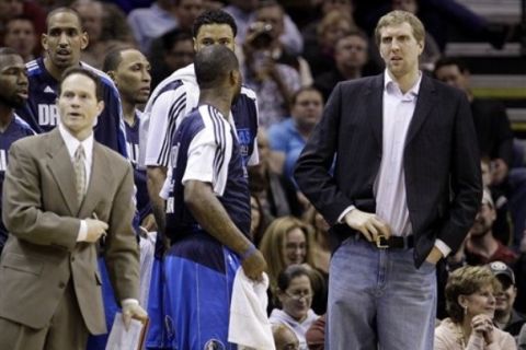  Dallas Mavericks' Dirk Nowitzki, right, of Germany, stands with teammates by the bench during the first quarter of an NBA basketball game against the San Antonio Spurs, Friday, Jan. 14, 2011, in San Antonio. Nowitzki is recovering from a sprained right knee. (AP Photo/Eric Gay)