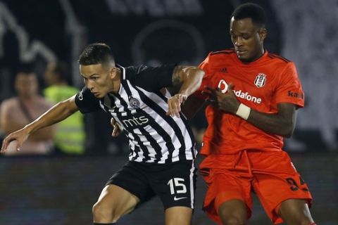 Partizan Belgrade's Svetozar Markovic, left, duels for the ball with Besiktas' Cyle Larin during the Europa League play-off first leg soccer match between Partizan and Besiktas at the Partizan stadium in Belgrade, Serbia, Thursday, Aug. 23, 2018. (AP Photo/Darko Vojinovic)