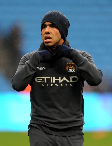 Manchester City's Carlos Tevez adjusts his snood before kick off