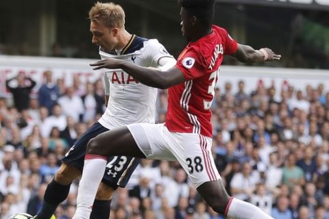 Tottenham's Christian Eriksen, left, challenges for the ball with Manchester United's Axel Tuanzebe during the English Premier League soccer match between Tottenham Hotspur and Manchester United at White Hart Lane stadium in London, Sunday, May 14, 2017. (AP Photo/Frank Augstein)