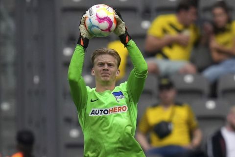 Berlin's goalkeeper Oliver Christensen catches the ball during the German Bundesliga soccer match between Hertha BSC Berlin and Borussia Dortmund in Berlin, Germany, Saturday, Aug. 27, 2022. (AP Photo/Michael Sohn)