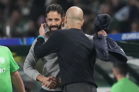 Sporting's head coach Ruben Amorim, left, shakes hand with Manchester City's head coach Pep Guardiola after the UEFA Champions League opening phase match between Sporting and Manchester City in Lisbon, Portugal, Tuesday, Nov. 5, 2024. (AP Photo/Armando Franca)