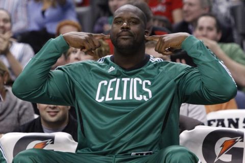 Boston Celtics Shaquille O'Neal plugs his ears as the crowd chants his name while his team plays the Toronto Raptors  during the second half of their NBA preseason basketball game in Toronto, October 15, 2010.     REUTERS/Mark Blinch (CANADA - Tags: SPORT BASKETBALL)