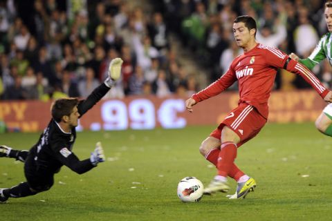 Real Madrid's Portuguese forward Cristiano Ronaldo (R) vies with Real Betis' goalkeeper Fabricio Brazio (L) during a Spanish League football match Real Madrid vs Betis on March 10, 2012 at Benito Villamarin stadium in Sevilla.     AFP PHOTO/ CRISTINA QUICLER (Photo credit should read CRISTINA QUICLER/AFP/Getty Images)