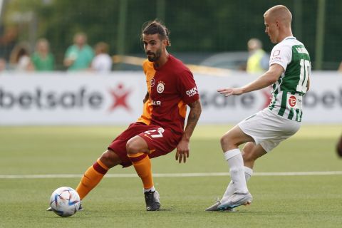 Galatasaray's Sergio Oliveira, left, fights for the ball with Zalgiris' Paulius Golubickas during the Champions League, second qualifying round, first leg soccer match between Zalgiris and Galatasaray at the LFF stadium in Vilnius, Lithuania, Tuesday, July 25, 2023. (AP Photo/Mindaugas Kulbis)