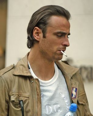 TOTTENHAM SUPERSTAR DIMITAR BERBATOV IS IN SMOKING FORM ON & OFF THE PITCH. THE STYLISH STRIKER WAS SPOTTED SMOKING A FAG WITH HIS WAG ON BOND STREET, CENTRAL LONDON YESTERDAY AFTERNOON.