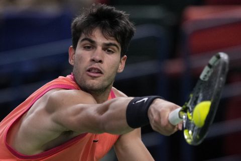 Carlos Alcaraz of Spain plays a backhand return against Tomas Machac of the Czech Republic during the men's singles quarterfinals match in the Shanghai Masters tennis tournament at Qizhong Forest Sports City Tennis Center in Shanghai, China, Thursday, Oct. 10, 2024. (AP Photo/Andy Wong)