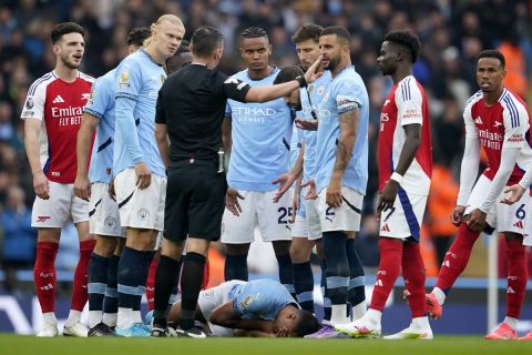 Manchester City's Rodri lays on the pitch after collision during the English Premier League soccer match between Manchester City and Arsenal at the Etihad stadium in Manchester, England, Sunday, Sept. 22, 2024. (AP Photo/Dave Thompson)