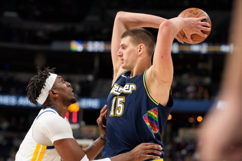 Denver Nuggets center Nikola Jokic, right, looks to pass the ball as Golden State Warriors center Kevon Looney defends in the second half of an NBA basketball game Monday, March 7, 2022, in Denver. (AP Photo/David Zalubowski)












