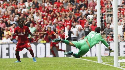 Manchester City's goalkeeper Claudio Bravo dives as the ball comes off the underside of the crossbar during the Community Shield soccer match between Manchester City and Liverpool at Wembley Stadium in London, Sunday, Aug. 4, 2019. (AP Photo/Frank Augstein)