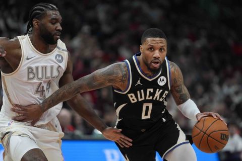 Chicago Bulls forward Patrick Williams, left, guards Milwaukee Bucks guard Damian Lillard during the first half of an NBA basketball game Saturday, Dec. 28, 2024, in Chicago. (AP Photo/Erin Hooley)