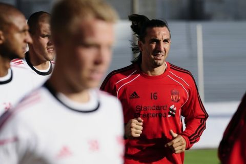 Liverpool player Sotirios Kyrgiakos (R) attends a training session in Skopje July 28, 2010. Liverpool will face Rabotnicki in the third qualifying round of the Europa League in Skopje on Thursday.
 REUTERS/Ognen Teofilovski (MACEDONIA - Tags: SPORT SOCCER)