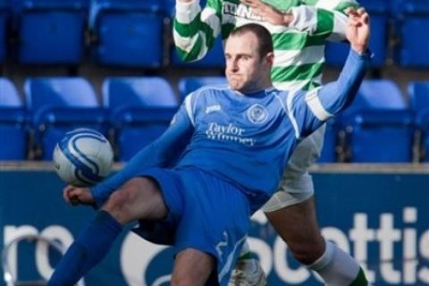 St Johnstone's Dave MacKay, front, clears the ball from the path of Celtic's Greek player Georgios Samaras, top, during the Clydesdale Bank Scottish Premier League soccer match at McDiarmid Park, in  Perth, Scotland, on Saturday Oct. 30, 2010. (AP Photo / Chris Clark, PA) ** UNITED KINGDOM OUT - NO SALES - NO ARCHIVES **