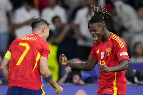 Spain's Nico Williams celebrates with Alvaro Morata, left, after scoring the opening goal during the final match between Spain and England at the Euro 2024 soccer tournament in Berlin, Germany, Sunday, July 14, 2024. (AP Photo/Manu Fernandez)