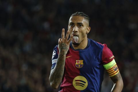 Barcelona's Raphinha celebrates after scoring a hat-trick and his side's fourth goal during a Champions League opening phase soccer match between Barcelona and Bayern Munich at the Lluis Companys Olympic Stadium in Barcelona, Spain, Wednesday, Oct. 23, 2024. (AP Photo/Joan Monfort)