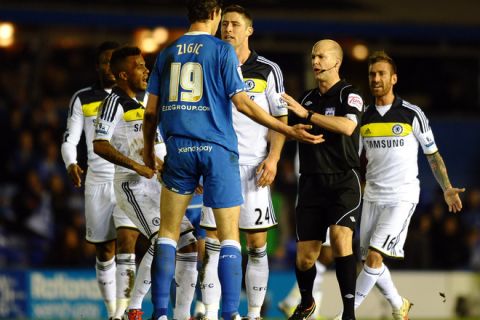 Chelsea's English midfielder Gary Cahill (3R) looks at Birmingham City's Serbian forward Nikola Zigic after a tackle during the English FA Cup replay football match between Birmingham City and Chelsea at St Andrews in Birmingham, central England on March 6, 2012. AFP PHOTO/PAUL ELLIS - RESTRICTED TO EDITORIAL USE. No use with unauthorized audio, video, data, fixture lists, club/league logos or live services. Online in-match use limited to 45 images, no video emulation. No use in betting, games or single club/league/player publications. (Photo credit should read PAUL ELLIS/AFP/Getty Images)