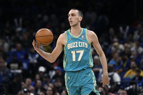 Charlotte Hornets forward Aleksej Pokusevski (17) brings the ball up the court during the second half of an NBA basketball game against the Orlando Magic, Tuesday, March 19, 2024, in Orlando, Fla. (AP Photo/Phelan M. Ebenhack)