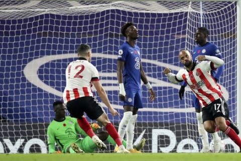 Sheffield United's David McGoldrick, front right, celebrates after scoring his side's opening goal during the English Premier League soccer match between Chelsea and Sheffield United at Stamford Bridge Stadium in London, Saturday, Nov. 7, 2020. (Peter Cziborra/Pool via AP)