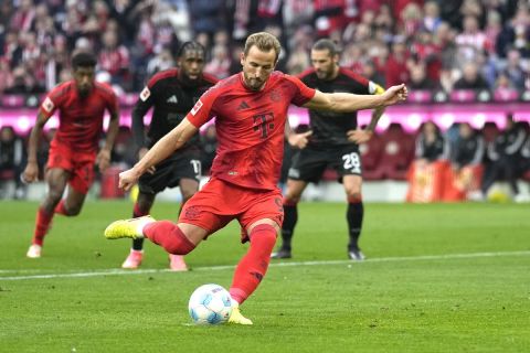 Bayern's Harry Kane shoots to score from the penalty spot during the Bundesliga soccer match between Bayern Munich and Union Berlin at the Allianz Arena in Munich, Germany, Saturday, Nov. 2, 2024. (AP Photo/Matthias Schrader)