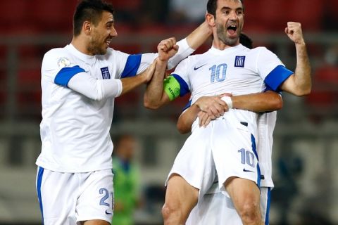 ATHENS, GREECE - OCTOBER 15:  Giorgos Karagounis of Greece celebrates scoring with team mates Kostas Katsouranis (L) and Dimitris Siovas after scoring his team's second goal during the group G FIFA 2014 World Cup Qualifier match between Greece and Liechtenstein at Karaiskakis Stadium on October 15, 2013 in Athens, Greece.  (Photo by Vladimir Rys/Getty Images)