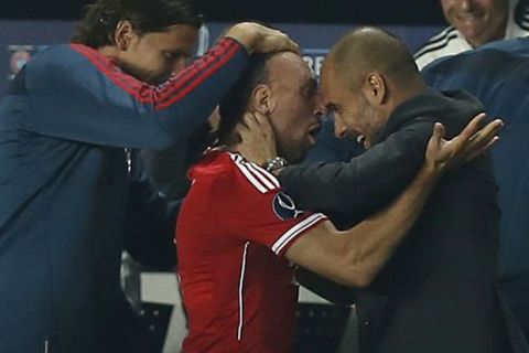 Bayern's Franck Ribery of France, left, and Bayern head coach Pep Guardiola celebrate after scoring during the soccer Super Cup final between Champions League winner Bayern Munich and Europa League winner Chelsea FC  at the Eden Stadium in Prague Friday, Aug. 30, 2013. (AP Photo/Petr David Josek) Czech Republic Soccer Super Cup