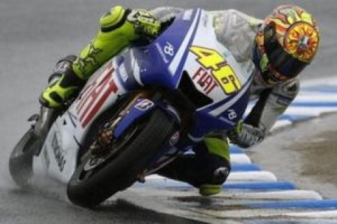 Italy's MotoGP rider Valentino Rossi on  his Yamaha takes a turn in the rain  during free practice, ahead of Sunday's Japanese motorcycling Grand Prix at Twin Ring Motegi circuit, north of Tokyo, Saturday, April 25, 2009.(AP Photo/Shuji Kajiyama)