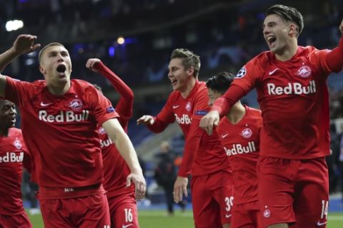 Salzburg players jubilate after winning a Champions League group E soccer match between Genk and Salzburg at the KRC Genk Arena in Genk, Belgium, Wednesday, Nov. 27, 2019. (AP Photo/Francisco Seco)