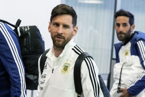 Lionel Messi, center, winks as the Argentina national soccer team arrive at Zhukovsky international airport outside Moscow, Russia, Saturday, June 9, 2018 to compete in the 2018 World Cup in Russia. The 21st World Cup begins on Thursday, June 14, 2018, when host Russia takes on Saudi Arabia. (AP Photo/Pavel Golovkin)