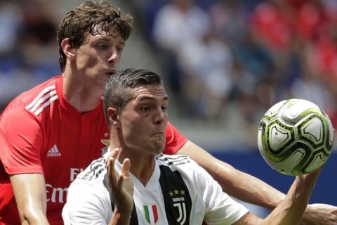 Benfica defender German Conti, back, defends against Juventus forward Andrea Favilli during the first half of an International Champions Cup tournament soccer match, Saturday, July 28, 2018, in Harrison, N.J. (AP Photo/Julio Cortez)