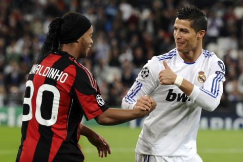 Real Madrid's Portuguese forward Cristiano Ronaldo (R) salutes AC Milan's Brazilian forward Ronaldinho before the UEFA Champions League Group G football match Real Madrid against Milan on October 19, 2010 at the Bernabeu stadium in Madrid.  AFP PHOTO/ DOMINIQUE FAGET (Photo credit should read DOMINIQUE FAGET/AFP/Getty Images)