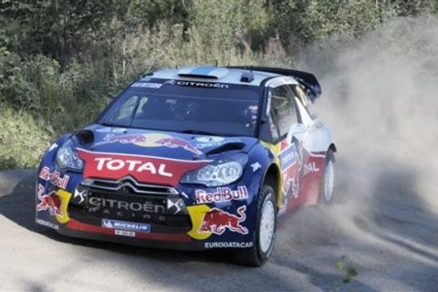 French Citroen driver Sebastien Ogier creates a cloud of dust and gravel at speed during the 4th special stage of the FIA World Rally Championship near Jamsa, Finland Friday July 29, 2011. (AP Photo/Lehtikuva, Martti Kainulainen)  FINLAND OUT  NO SALES  