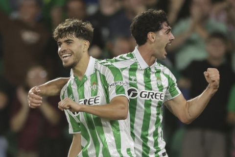 Betis' Abde Ezzalzouli, left, celebrates with Johnny Cardoso after scoring the opening goal during a Europa Conference League soccer match between Betis and Copenhagen at the Benito Villamarin stadium in Seville, Spain, Thursday, Oct. 24, 2024. (AP Photo/Toni Rodriguez)