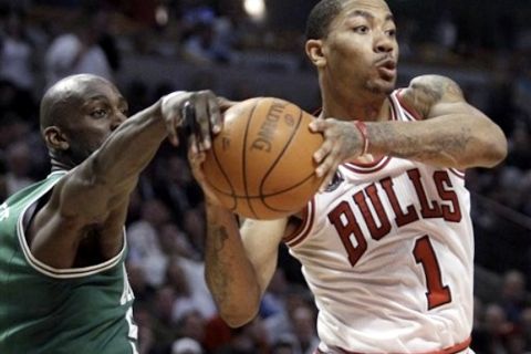 Chicago Bulls' Derrick Rose, right, looks to pass against Boston Celtics' Kevin Garnett, left, during the third quarter of an NBA basketball game in Chicago, Thursday, April 7, 2011. The Bulls won 97-81. (AP Photo/Nam Y. Huh)