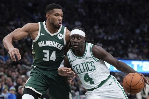 Boston Celtics' Jrue Holiday tries to get past Milwaukee Bucks' Giannis Antetokounmpo during the first half of an NBA basketball game Sunday, Nov. 10, 2024, in Milwaukee. (AP Photo/Morry Gash)