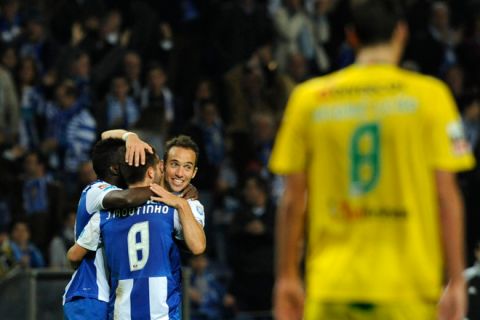 FC Porto's midfielder Joao Moutinho (L) is congratulated by teammates after scoring a goal during the Portuguese super league football match FC Porto vs Pacos Ferreira at the Dragao Stadium in Porto, on October 28, 2011. Porto won the match 3-0. AFP PHOTO / MIGUEL RIOPA (Photo credit should read MIGUEL RIOPA/AFP/Getty Images)