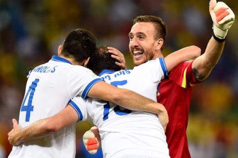 FORTALEZA, BRAZIL - JUNE 24:  (L-R) Konstantinos Manolas, Vasilis Torosidis and Panagiotis Glykos of Greece celebrate after defeating the Ivory Coast 2-1 during the 2014 FIFA World Cup Brazil Group C match between Greece and the Ivory Coast at Castelao on June 24, 2014 in Fortaleza, Brazil.  (Photo by Jamie McDonald/Getty Images)