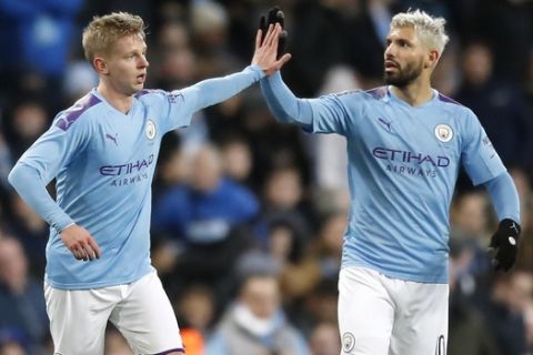 Manchester City's Oleksandr Zinchenko, left, celebrates scoring his side's first goal of the game with teammate Sergio Aguero during the English FA Cup third round soccer match between Manchester City and Port Vale at the Etihad Stadium, Manchester, England, Saturday, Jan. 4, 2020. (Martin Rickett/PA via AP)