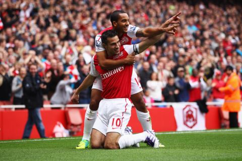 LONDON, ENGLAND - OCTOBER 16:  Robin van Persie of Arsenal (10) celebrates with Theo Walcott as he scores their first goal during the Barclays Premier League match between Arsenal and Sunderland at the Emirates Stadium on October 16, 2011 in London, England.  (Photo by Julian Finney/Getty Images)