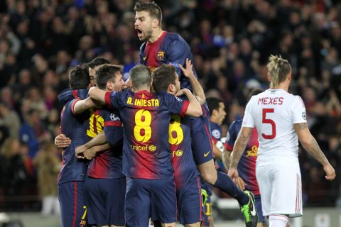 Barcelona's players celebrate their first score during the UEFA Champions League round of 16 second leg football match FC Barcelona against AC Milan at Camp Nou stadium in Barcelona on March 12, 2013. AFP PHOTO / QUIQUE GARCIA        (Photo credit should read QUIQUE GARCIA/AFP/Getty Images)