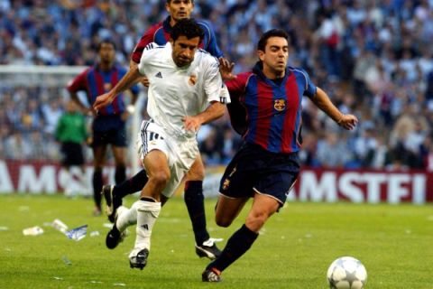 Real Madrid's Luis Figo battles battles for possession of the ball with Barcelona's Xavi