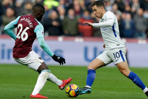 Chelsea's Eden Hazard, right, is challenged by West Ham United's Arthur Masuaku during the English Premier League soccer match between West Ham United and Chelsea at the London stadium in London, Saturday, Dec. 9, 2017. (AP Photo/Alastair Grant)