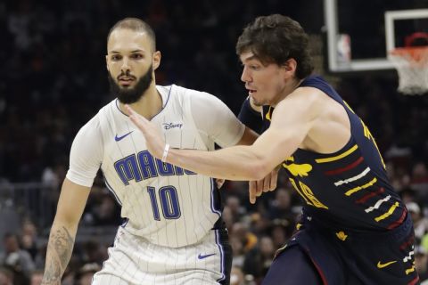 Orlando Magic's Evan Fournier (10) drives past Cleveland Cavaliers' Cedi Osman (16) in the second half of an NBA basketball game, Wednesday, Nov. 27, 2019, in Cleveland. (AP Photo/Tony Dejak)